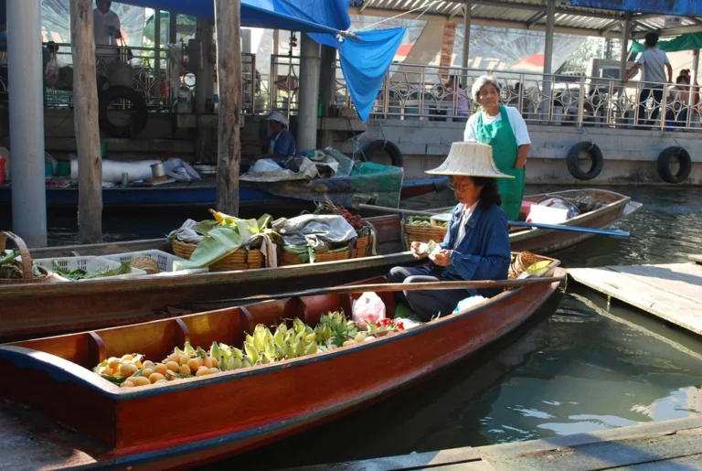 The Taling Chan Floating Market lady on boat selling food